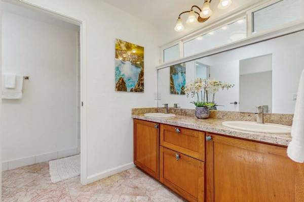 Bathroom featuring a long, wood-grained vanity cabinet