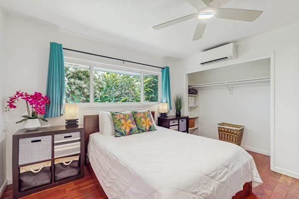 Compact bedroom designed with a breezy, tropical aesthetic