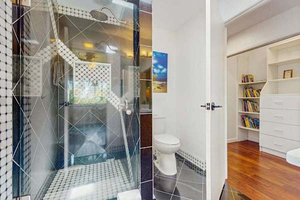 A glass-enclosed walk-in shower is designed with a modern, contemporary aesthetic