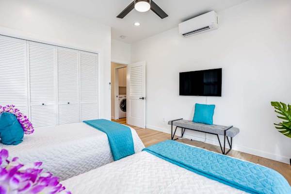 Bright bedroom with TV and workspace