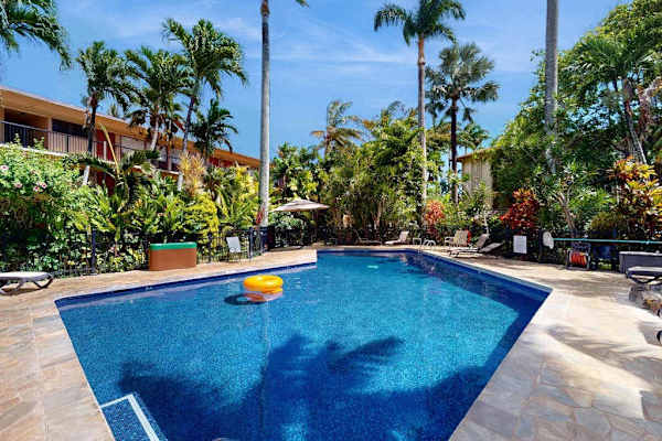 Relax by the resort pool under sunny skies