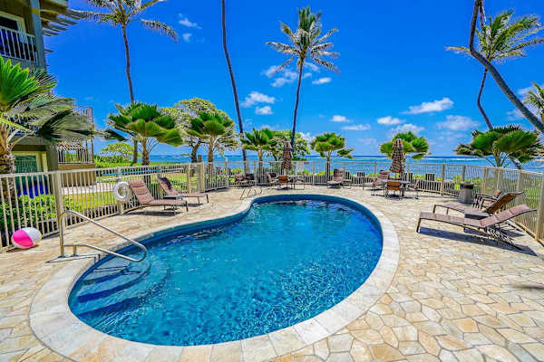 Relax poolside surrounded by tropical landscaping