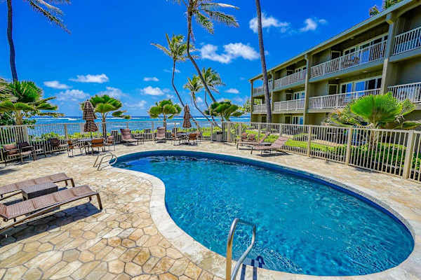 Relax poolside surrounded by tropical landscaping