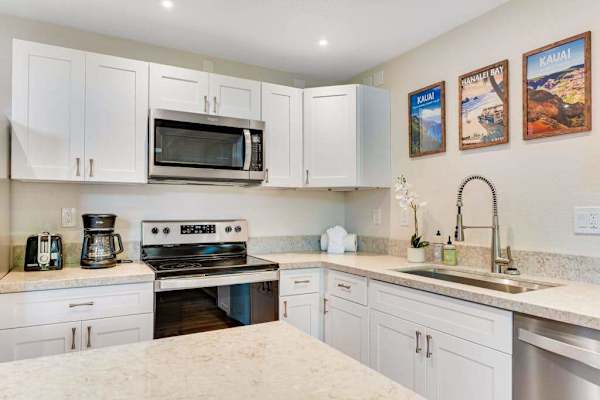 Spacious stainless steel kitchen with an open-concept design, allowing you to enjoy abundant natural light while staying connected with family and friends.