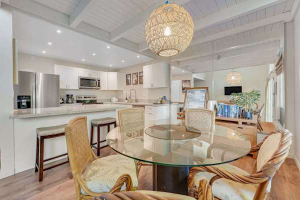 Dining room open to the kitchen with barstools for extra seating. 