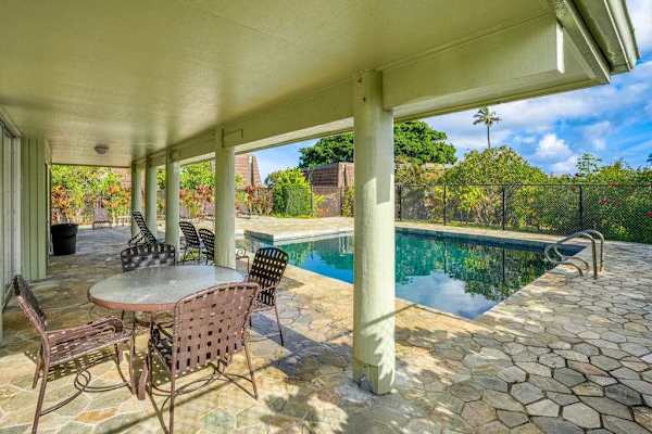 Princeville Paradise at Puamana community pool with covered seating to relax in the shade.