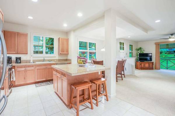 Newly remodeled kitchen with stainless steel appliances and a large island for extra counter space.   Two barstools for extra seating.