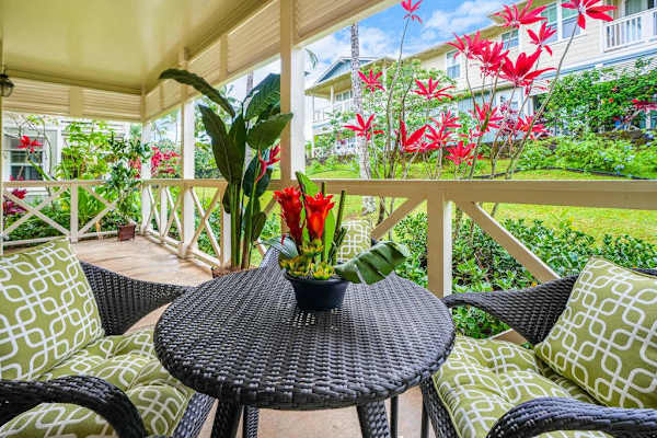 Private lanai surrounded by lush tropical paradise, vibrant flowers, and swaying palms—the perfect place to relax and soak in the island atmosphere.