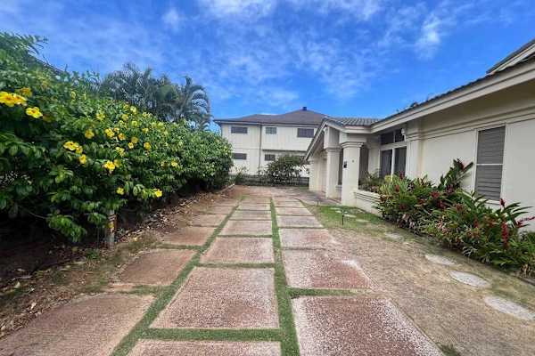 Stroll through beautiful landscaping before heading inside