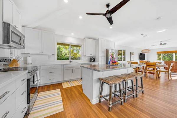 Modern kitchen center island seating and adjacent dining area