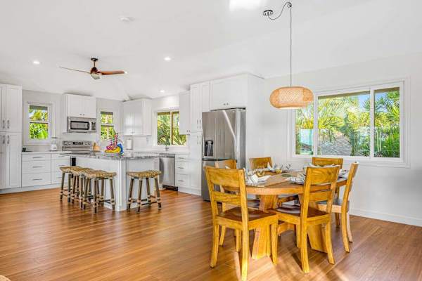Open dining and kitchen layout with wooden dining set and kitchen island 