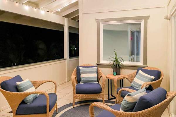 Outdoor covered patio lounge with comfortable armchair seating