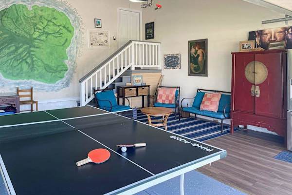 Game room featuring ping-pong table, lounge seating & loft view