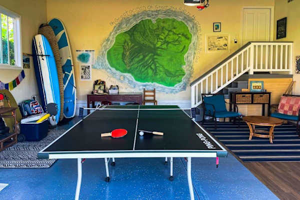 Spacious game room with ping-pong, surfboard storage & lounge area