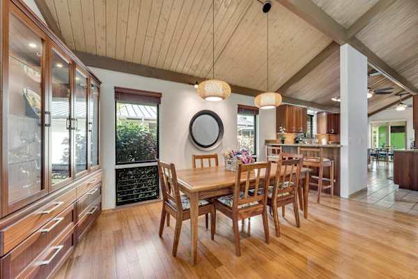 Warm dining table gathers beneath vaulted ceilings and pendant lights