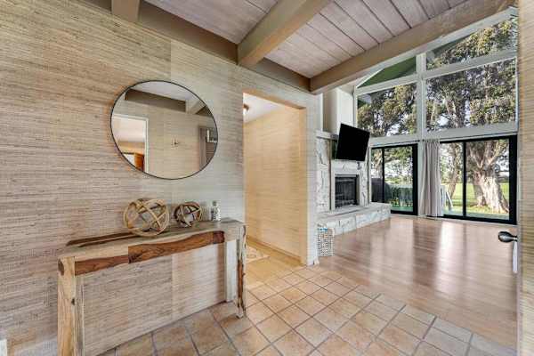Open interior showcases tall ceilings warm wood and garden views