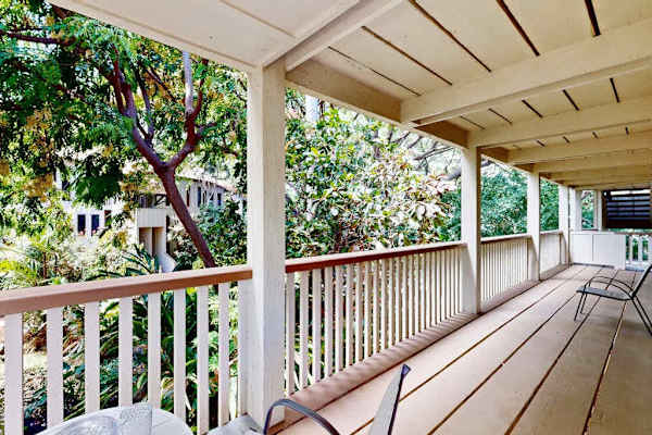Spacious lanai overlooking lush tropical greenery
