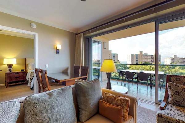 Cozy living and dining area featuring a comfortable armchair and warm lighting, perfect for relaxing with a good book.