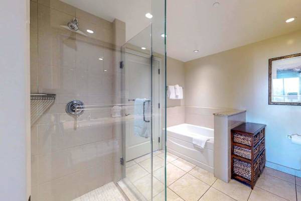 Refresh, relax, and recharge in our comfortable bathroom featuring a modern walk-in shower and a soaking tub
