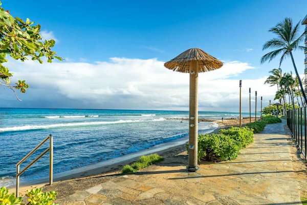 Scenic beachfront path with a shaded palapa, right outside the property.