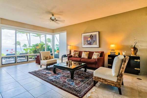 Living room with comfortable seating with floor to ceiling windows for you to take in the amazing views of your tropical paradise.