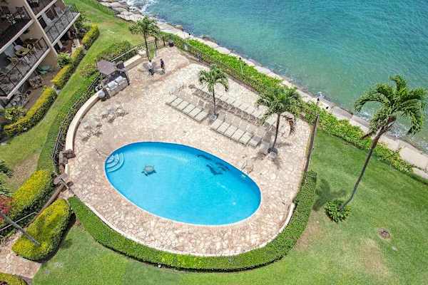 Aerial view of Hololani Resort community pool.  Amazing pool, swaying palm trees and steps to the ocean.