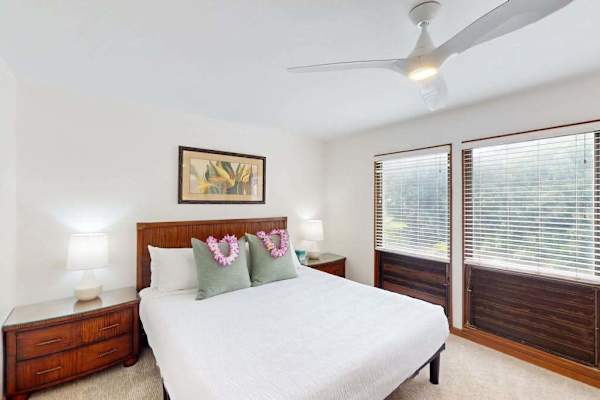 Spacious king bedroom with large windows and natural light