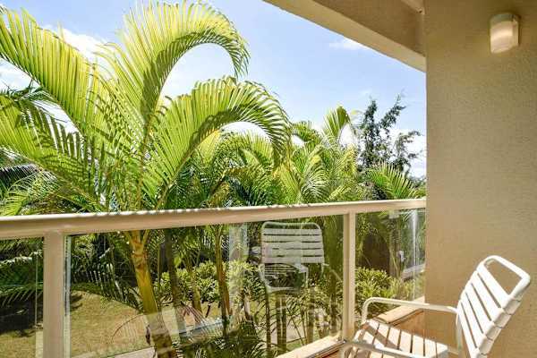 Covered lanai overlooking peaceful tropical greenery