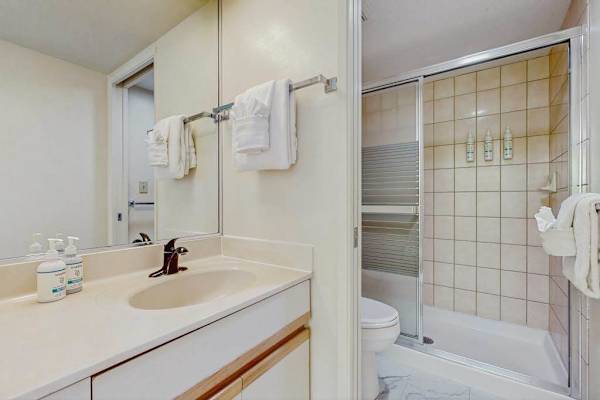 Full bathroom with spacious vanity and tub-shower combination
