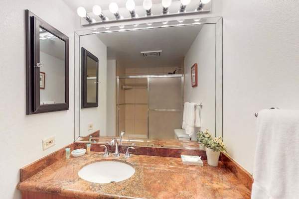 Full bathroom with generous vanity space and bright lighting