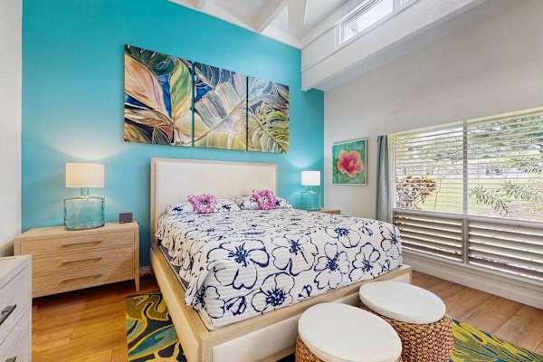 Peaceful sleeping space features comfortable bedding, tasteful furnishings, and soothing decorative touches
