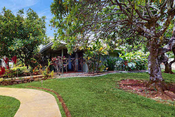 Home exterior blends design with landscaped grounds and convenient access