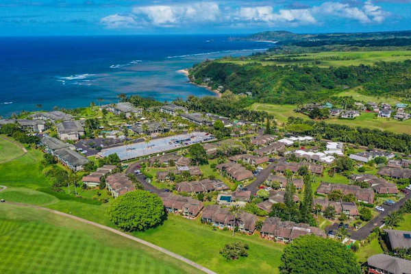Inviting bird-eye view showcases charming architecture, welcoming entry, and beautiful surrounding views