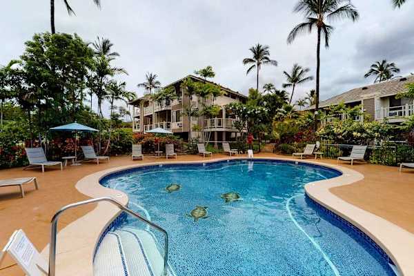 Cool off in the sparkling resort pool surrounded by palms