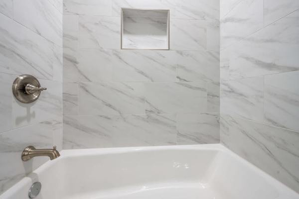 Relax in the clean and inviting tub-shower combination