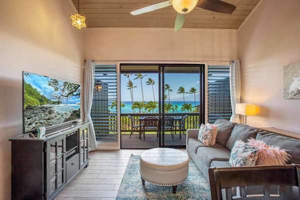 Living room with flat screen tv, sleeper sofa and easy access to the lanai
