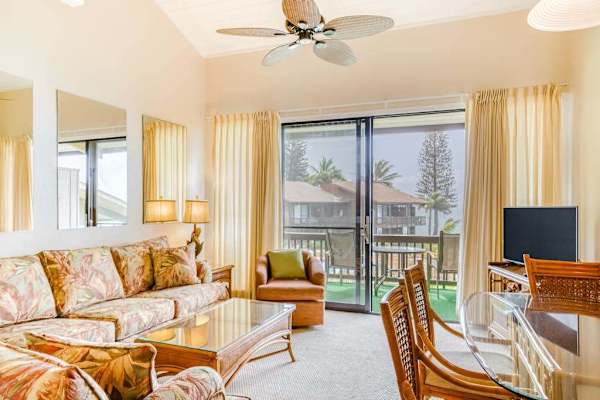 Living space with lanai access and sleeper sofa for additional guests