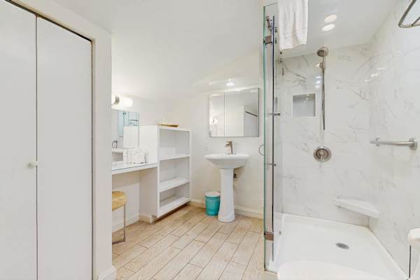 Guest bathroom with walk-in tiled shower.