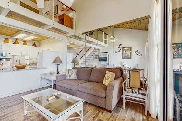 Comfortable living space open to the loft above with lots of natural light streaming in from the lanai.