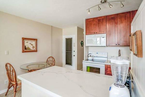 Full kitchen and a dining table for two.