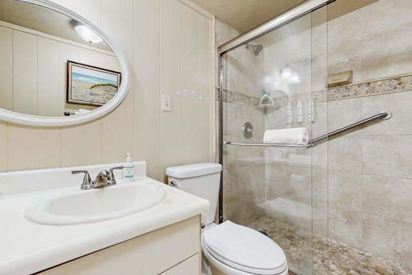 Newly remodeled guest bedroom with walk in tiled shower.