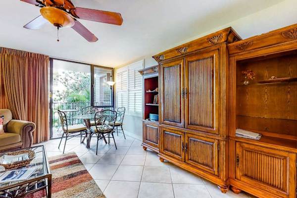 Open living space with entertainment center and balcony access