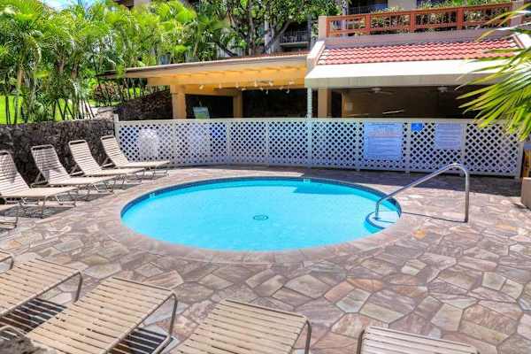 Refreshing resort pool surrounded by tropical landscaping