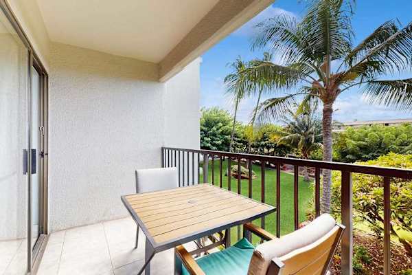 Private lanai with seating for two overlooking lush tropical paradise—perfect for morning coffee or sunset relaxation.