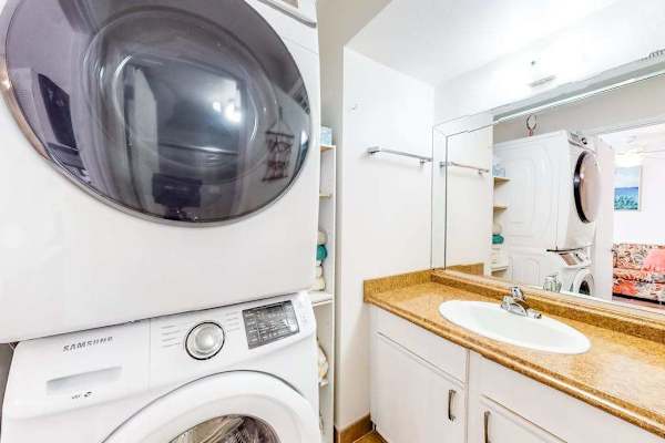 Bright bathroom with generous counter space, convenient drawers, and fresh towels ready for your stay