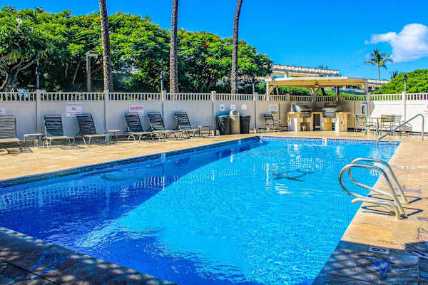 Resort Swimming Pool Deck with Lounge Chairs and BBQ Grilling Area