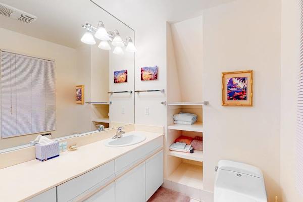 Bathroom includes dual vanity mirrors bathtub and convenient storage