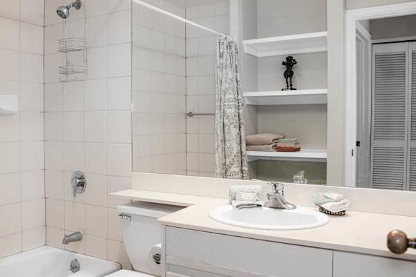 Full bathroom offers shower vanity mirror and practical storage space