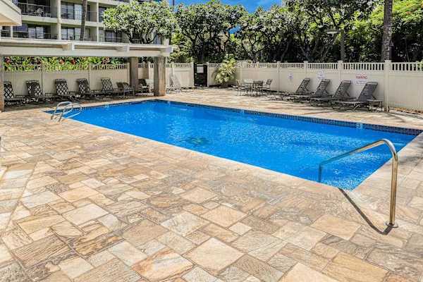 Resort pool with lounge chairs for sunny afternoons