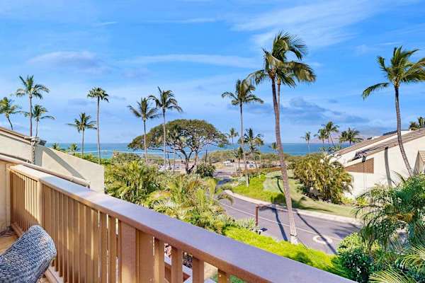 Private Covered Balcony View Overlooking Palm Trees and Ocean Horizon
